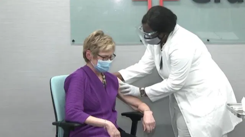 DPH Commissioner Dr. Kathleen Toomey receives a COVID-19 vaccine.