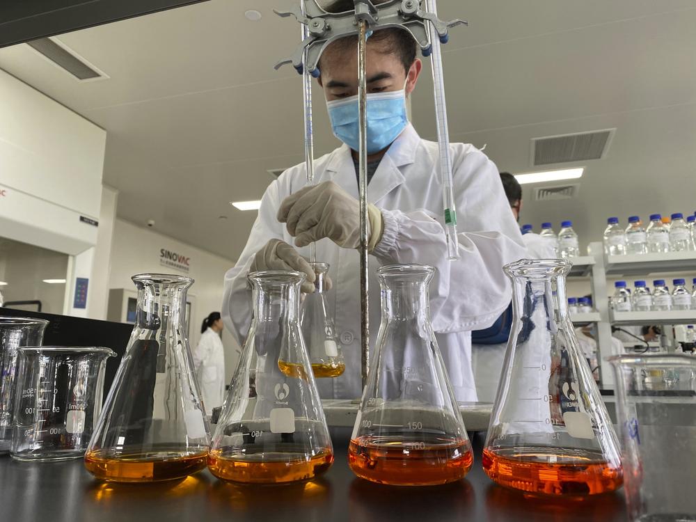 A worker works inside a lab at the SinoVac vaccine factory in Beijing on Thursday, Sept. 24, 2020. SinoVac, one of China's pharmaceutical companies behind a leading COVID-19 vaccine candidate says its vaccine will be ready by early 2021 for distribution worldwide, including the U.S.