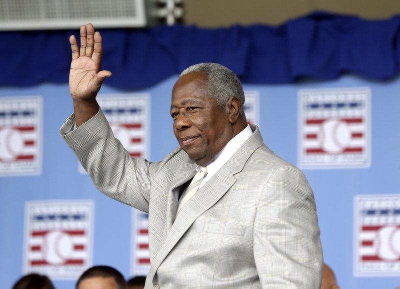 Hall of Famer Hank Aaron waves to the crowd during Baseball Hall of Fame induction ceremonies in Cooperstown, N.Y., in this Sunday, July 28, 2013, file photo. 