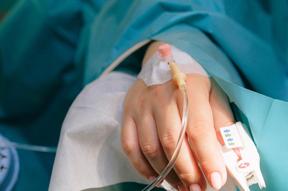 Person with IV in hand