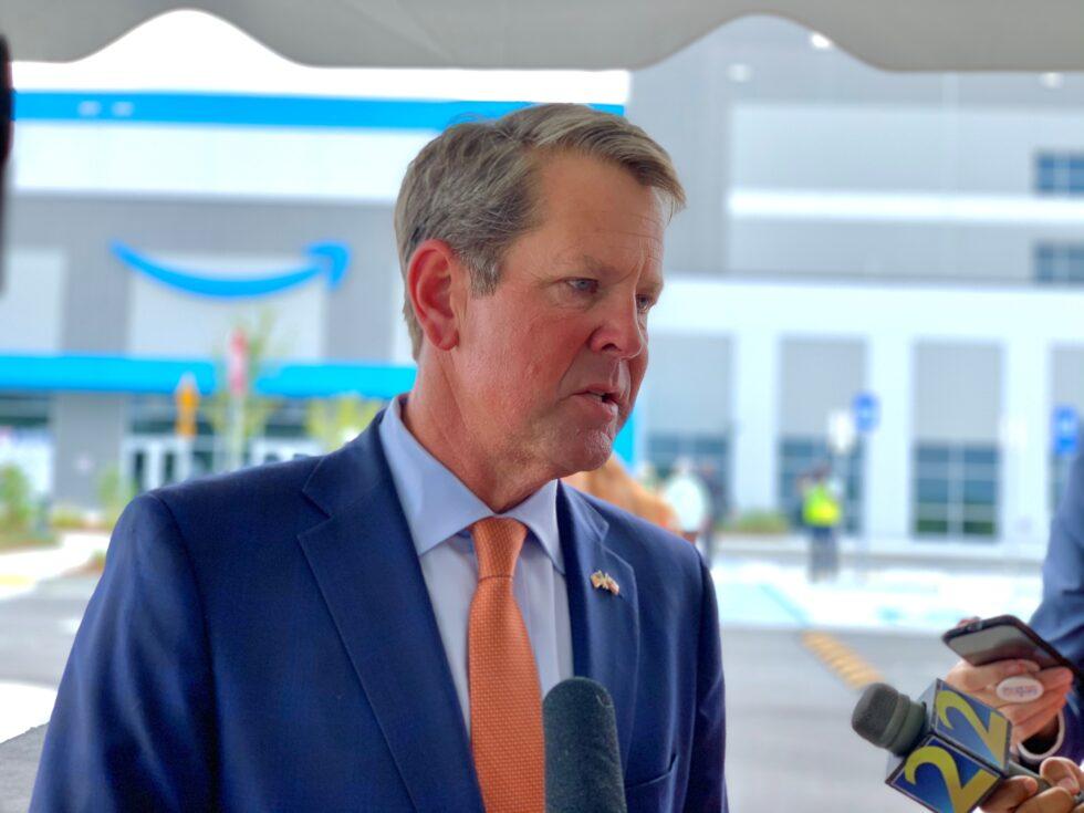 Gov. Brian Kemp speaks with reporters outside Amazon’s new warehouse in Gwinnett County on Sept. 1, 2020.