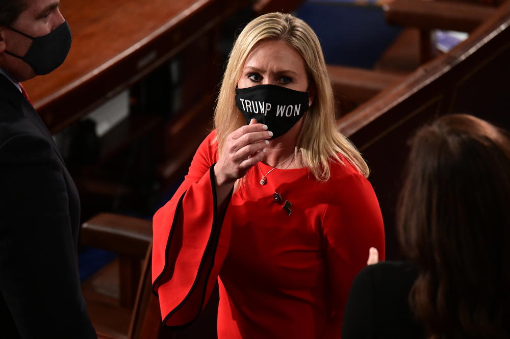 In this Sunday, Jan. 3, 2021, file photo, Rep. Marjorie Taylor Greene, R-Ga., wears a "Trump Won" face mask as she arrives on the floor of the House to take her oath of office on opening day of the 117th Congress at the U.S. Capitol in Washington.