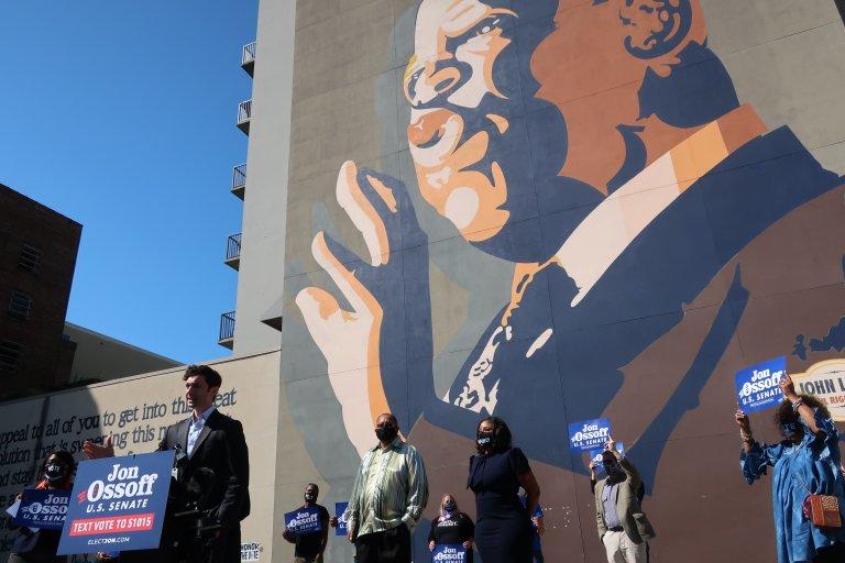 U.S. Senate candidate Jon Ossoff speaks to reporters in front of a mural in downtown Atlanta paying tribute to the late U.S. Congressman John Lewis, who backed Ossoff before his death.