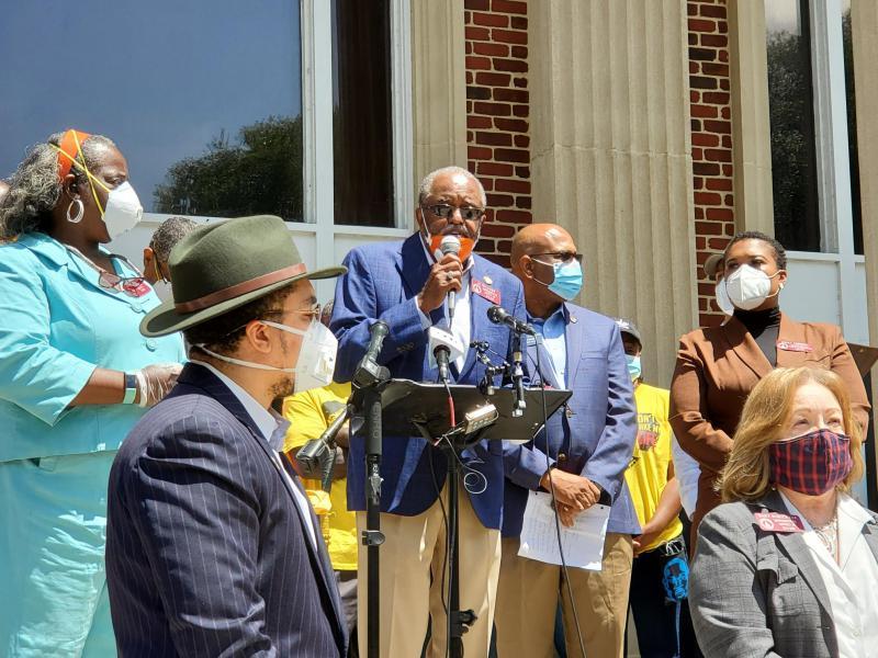 State Rep. Al Williams stands at podium May 12, 2020, during a press conference and meeting with other lawmakers in Brunswick to call for passage of a hate crimes law following the shooting death of Ahmaud Arbery.