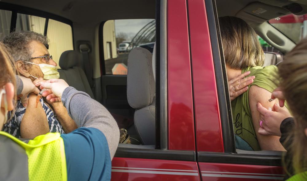 Betty Smith, 84, left, got her first dose of the Moderna vaccine at a drive thru event in Cochran recently.  "I felt proud," Smith said when asked how the shot felt. "I hope it helps."