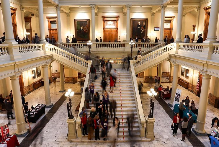The interior of the state capitol busy with people.