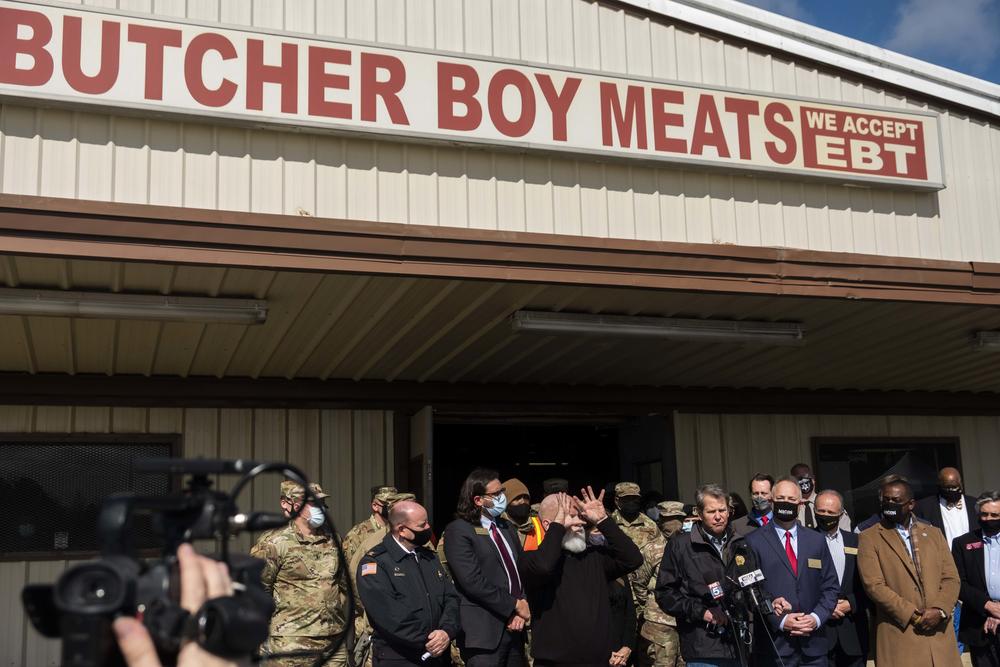 Governor Brian Kemp, Macon-Bibb County political leaders and others after a tour of the mass vaccination site at the state farmers market in Macon Friday. 