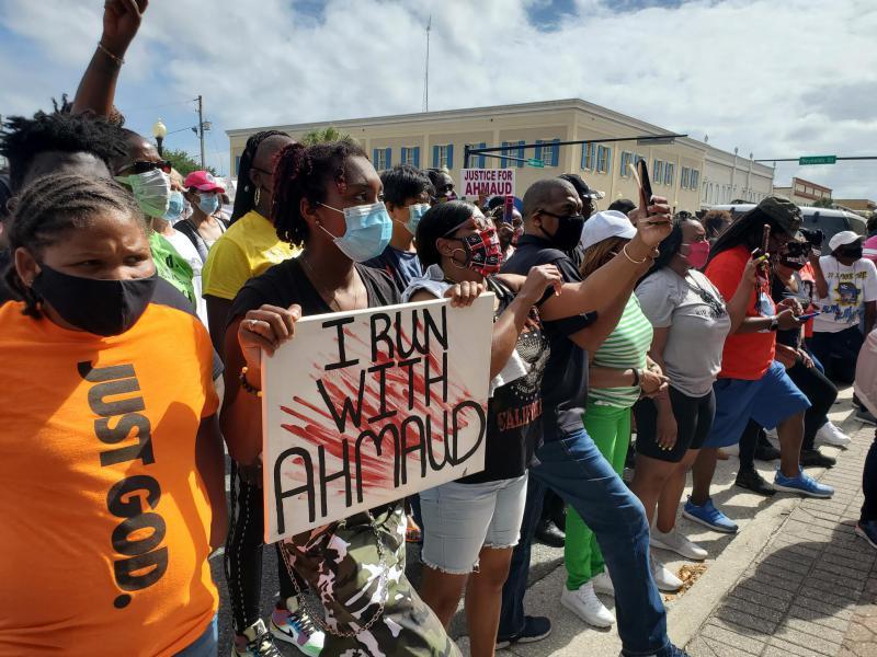 Protesters gather in front of the Brunswick City Hall during a march for Ahmaud Arbery.