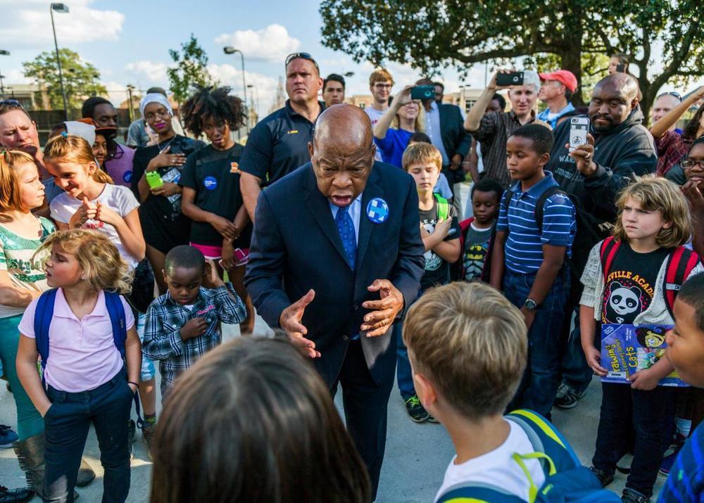 2016 photo of Rep. John Lewis speaking to children in a Macon park.