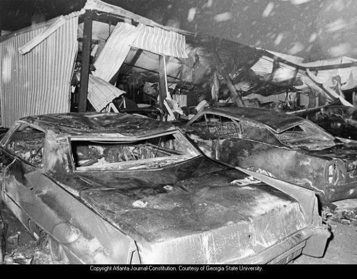 Cars lie smashed outside Thiokol Plant (left) and building is destroyed after powerful explosion and fire; debris, charred equipment shown inside the structure. 