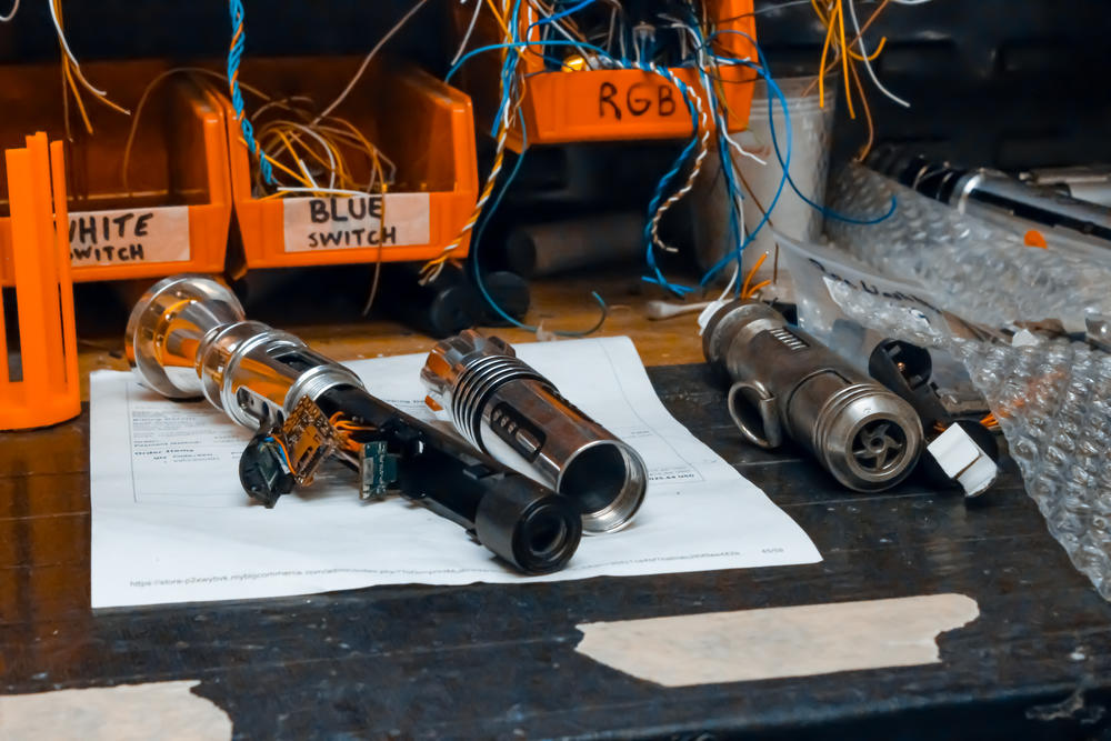 Lightsabers-in-progress on a Vader's Vault workbench.