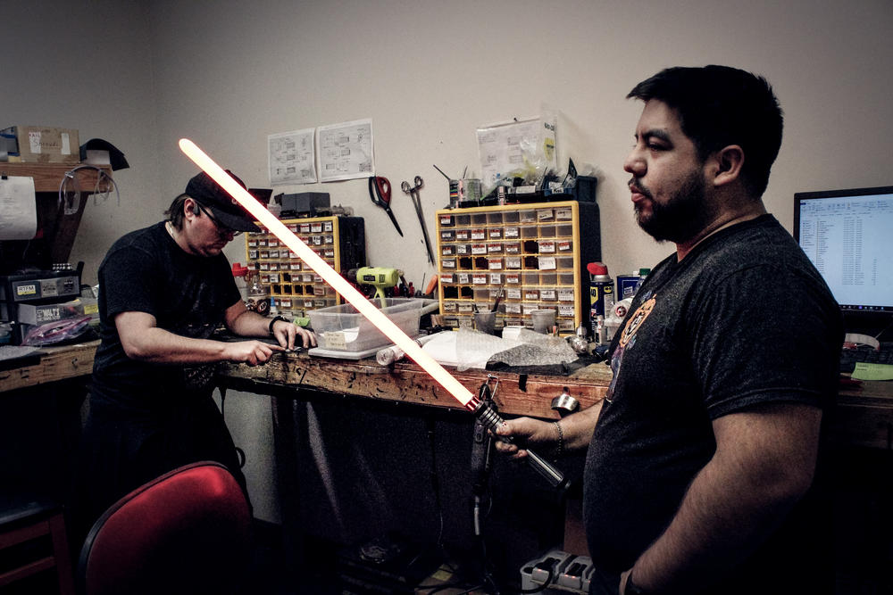 Vader's Vault employees test lightsabers in their workshop.