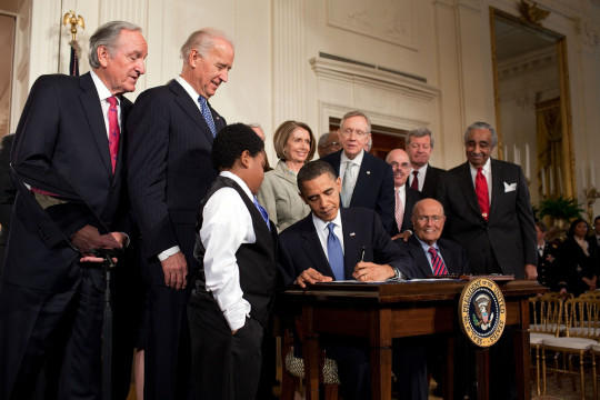 President Obama signing the Affordable Care Act