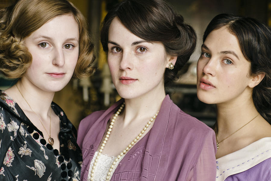 Three young women in period dress.