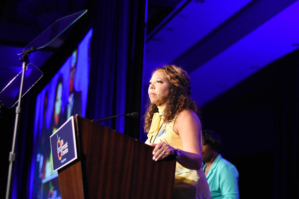 U.S. Rep. Lucy McBath speaks at a podium in 2018.