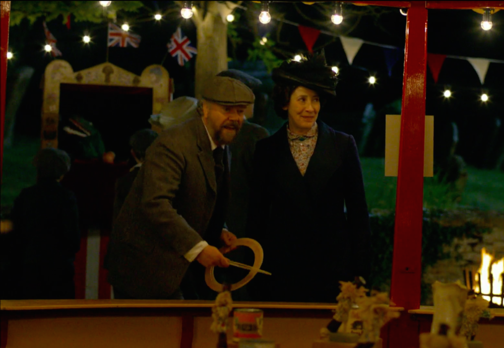 A man and woman playing a game at a fair.