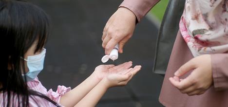 Child getting hand sanitizer