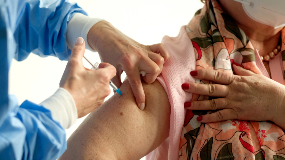 A women receives a vaccine shot.
