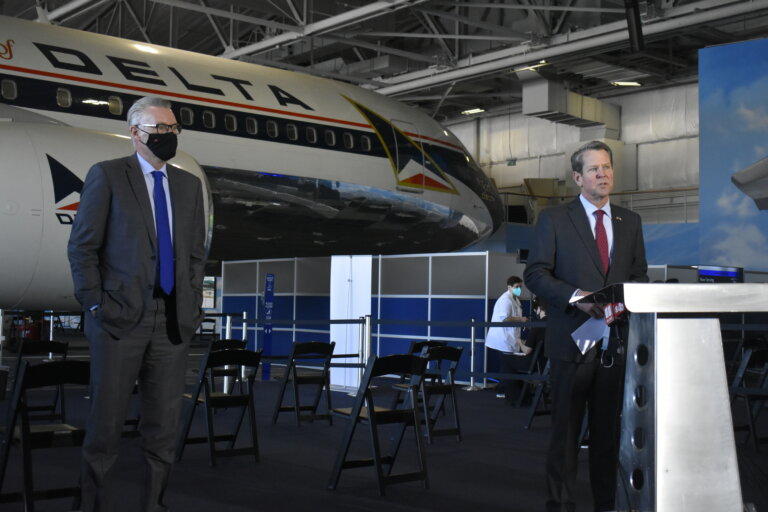 Gov. Brian Kemp and Delta CEO Ed Bastian met at the Delta Air Museum in Atlanta in February to tour the vaccination site there.