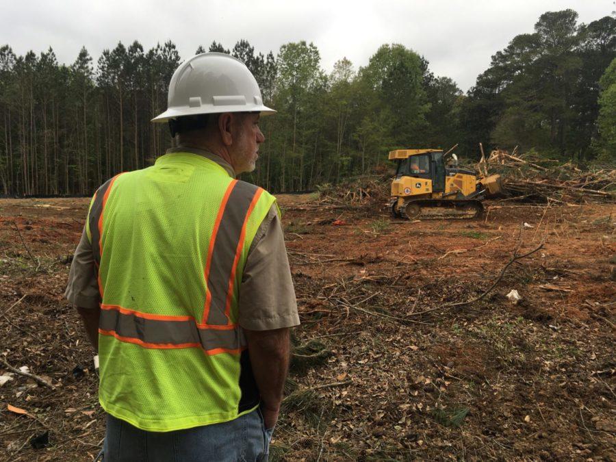 Piedmont Construction’s Randall Posey checks progress on clearing land at 3568 Northside Drive for a new senior citizen affordable housing complex.