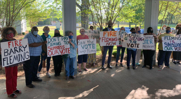 Protesters lined up Monday outside the Washington City Council chambers to call for the firing of GOP Rep. Barry Fleming as the city attorney for his role in writing controversial new state voting laws. 