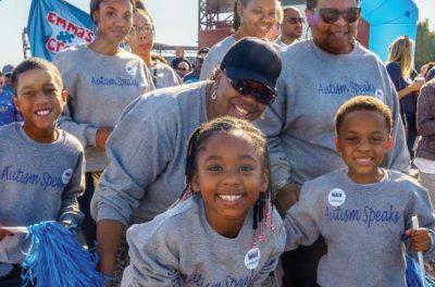 Children and adults wearing Autism Speaks shirts.