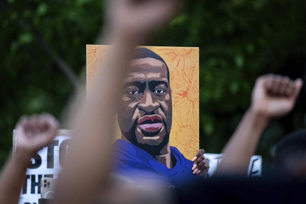 A poster of George Floyd held by protestors in Atlanta.