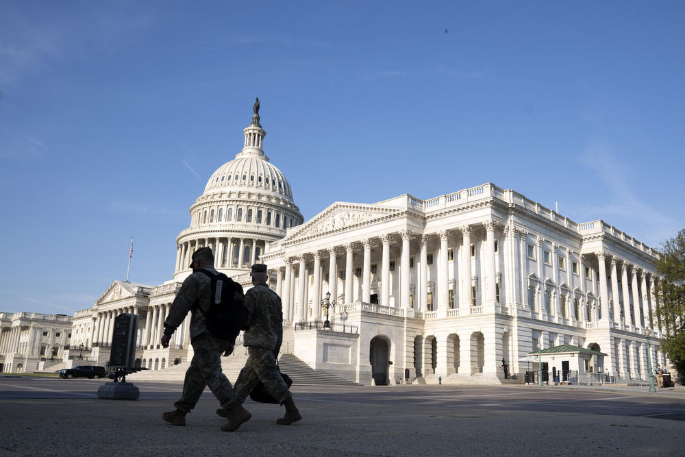 The U.S. Capitol is seen as national guard members pass by on Capitol Hill in Washington, Thursday, May 20, 2021.