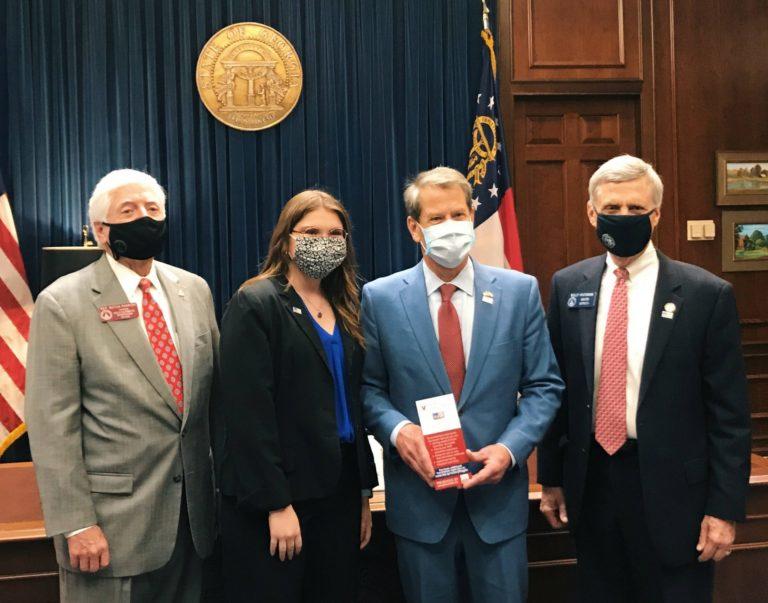 Edie Grice with lawmakers and Gov. Kemp
