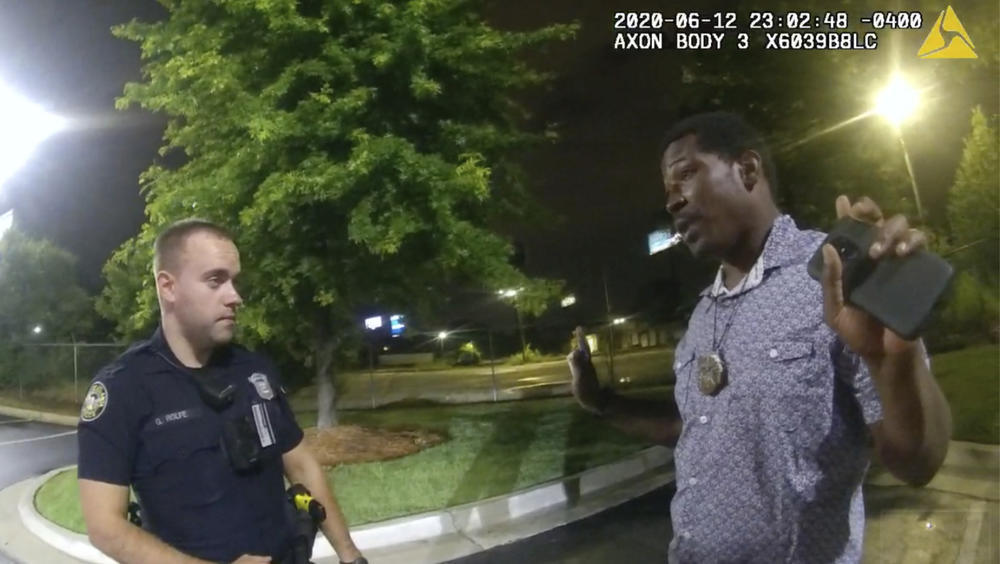 In this June 12, 2020 file photo from a screen grab taken from body camera video provided by the Atlanta Police Department Rayshard Brooks speaks with Officer Garrett Rolfe in the parking lot of a Wendy's restaurant, in Atlanta.