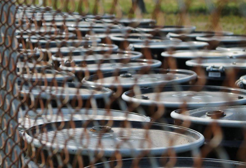 At least 100 barrels up against a fence on the edge of the Terry Creek Superfund site contain samples from newly installed wells. 