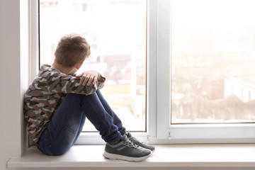 Kid sitting in window