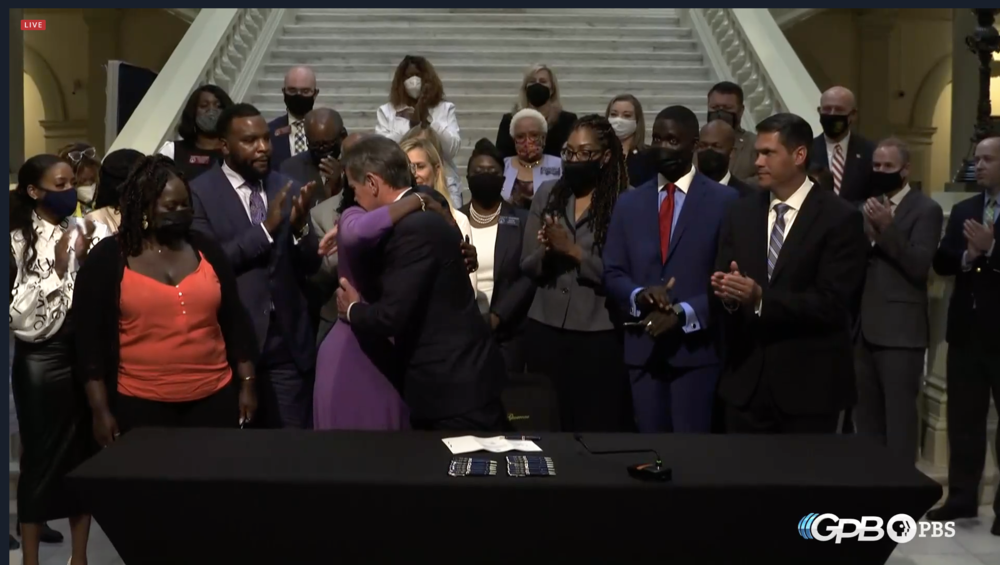 Gov. Brian Kemp hugs Wanda Cooper-Jones. mother of Ahmaud Arbery