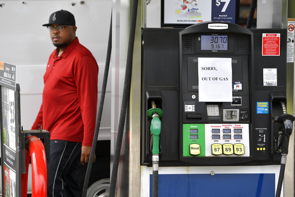 A man leaves a Murrphy Oil gas station as pumps are seen out of gas, Tuesday, May 11, 2021, in Kennesaw, Ga. Colonial Pipeline, which delivers about 45% of the fuel consumed on the East Coast, halted operations last week after revealing a cyberattack that it said had affected some of its systems.