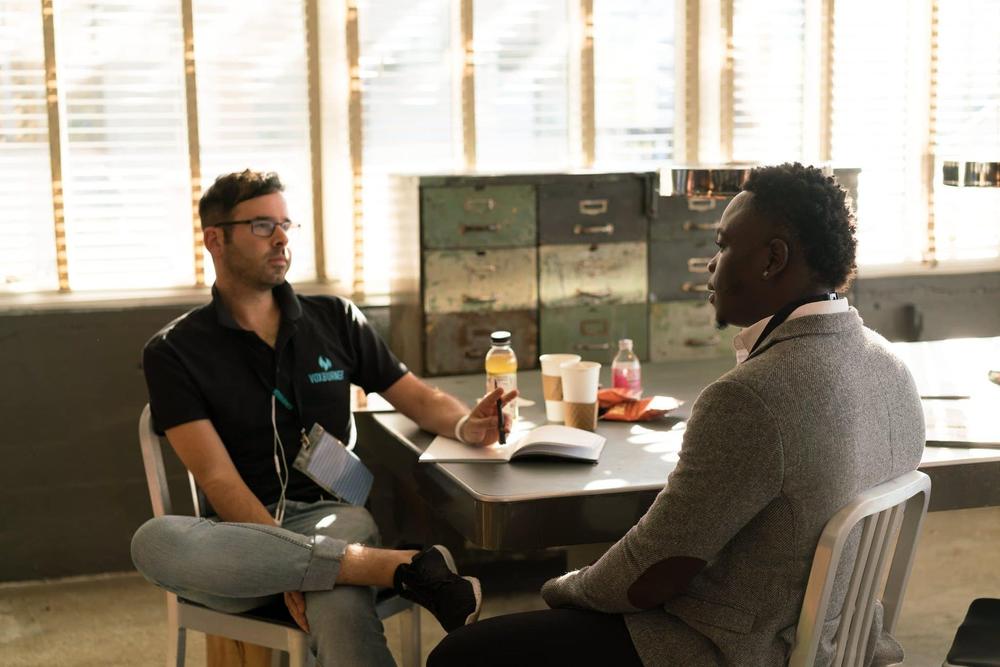 People talking at a table in an office.