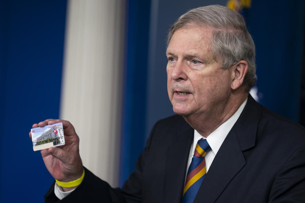 Agriculture Secretary Tom Vilsack holds up a Supplemental Nutrition Assistance Program Electronic Benefits Transfer (SNAP EBT) card during a press briefing at the White House, Wednesday, May 5, 2021, in Washington.