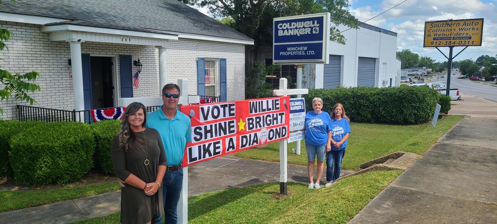 From Left to Right, Douglas residents Carrie and Jim Minchew, Rebecca Underwood, and Gina Harrell stand around a sign supporting American Idol Finalist Willie Spence.