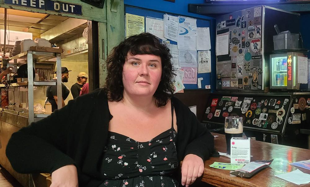 Nurse Andy Gish sits at the bar at The Earl next to a naloxone kit. 