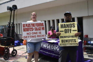 Lauren Crace and Marcellus Rowe protested outside the Georgia Department of Labor headquarters in Atlanta Thursday ahead of the end of expanded unemployment benefits in the state.