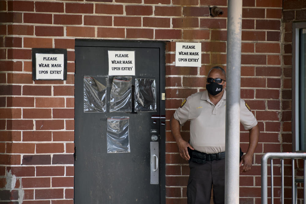 A Fulton County Sheriff's Deputy guards the entrance to the county's election preparation warehouse after an alarm elsewhere in the building was triggered over the weekend.