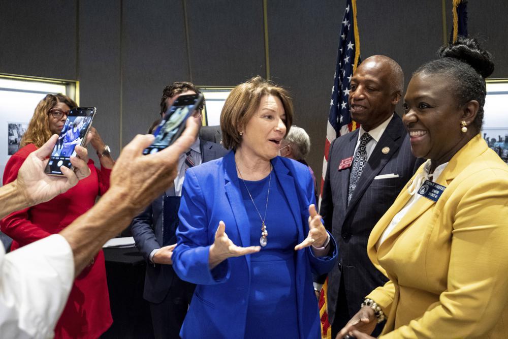 Sen. Amy Klobuchar, center, D-Minn., talks with Georgia State Legislators following a Senate Rules Committee field hearing on voting rights at the National Center for Civil and Human Rights in Atlanta, Monday, July 19, 2021.