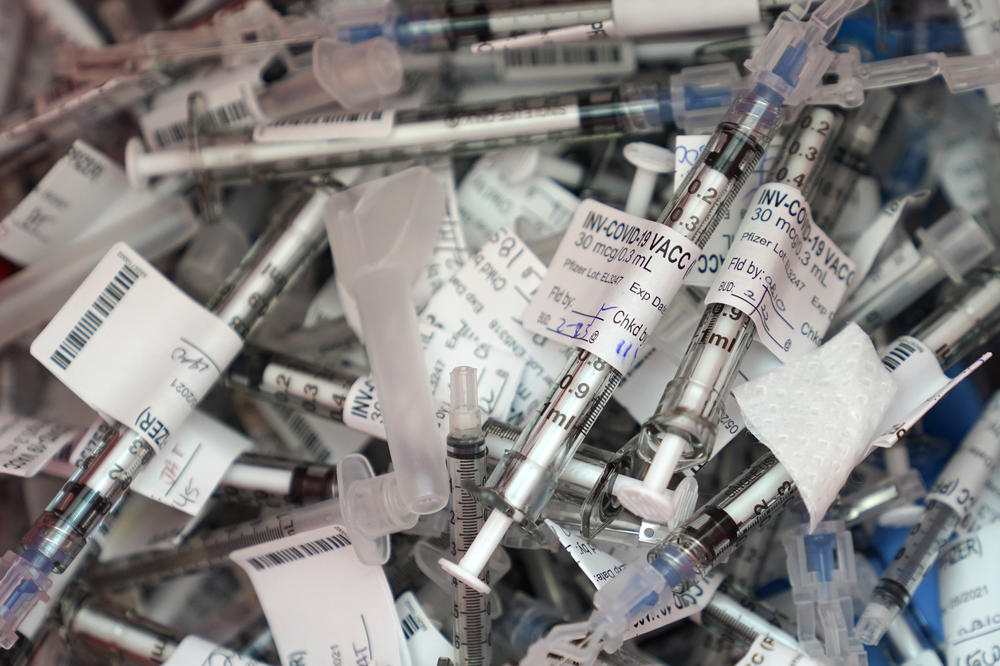 Used COVID-19 vaccination syringes used to administer the Pfizer vaccine are shown in a container Tuesday, Feb. 23, 2021, at the VA Puget Sound Health Care System campus in Seattle. 