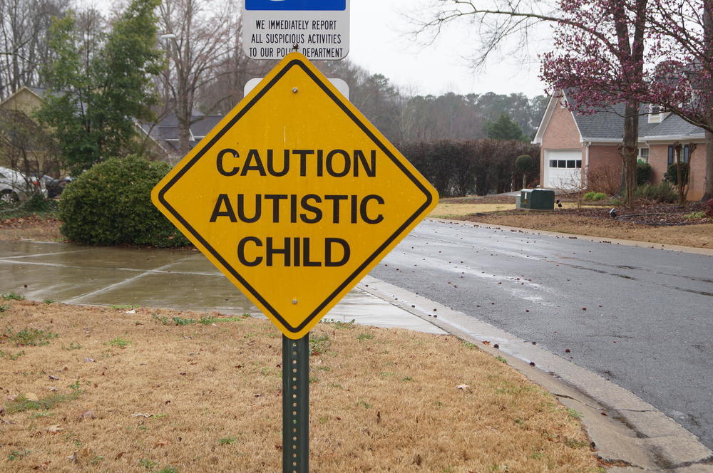 A road sign that says Caution Autistic Child