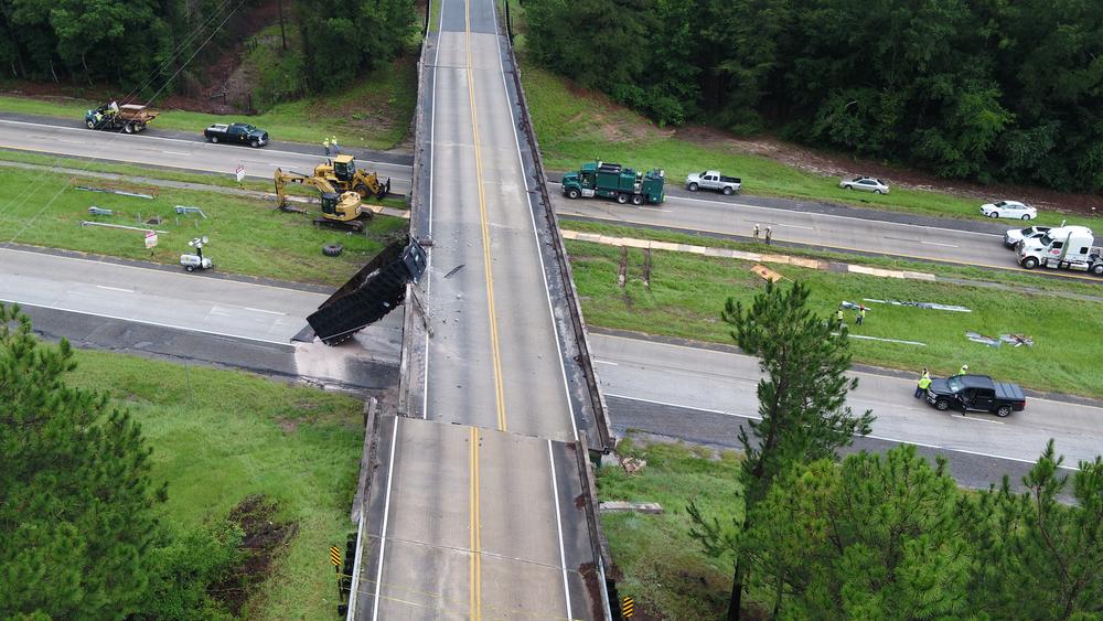 aerial photo showing a damaged highway overpass struck by a truck