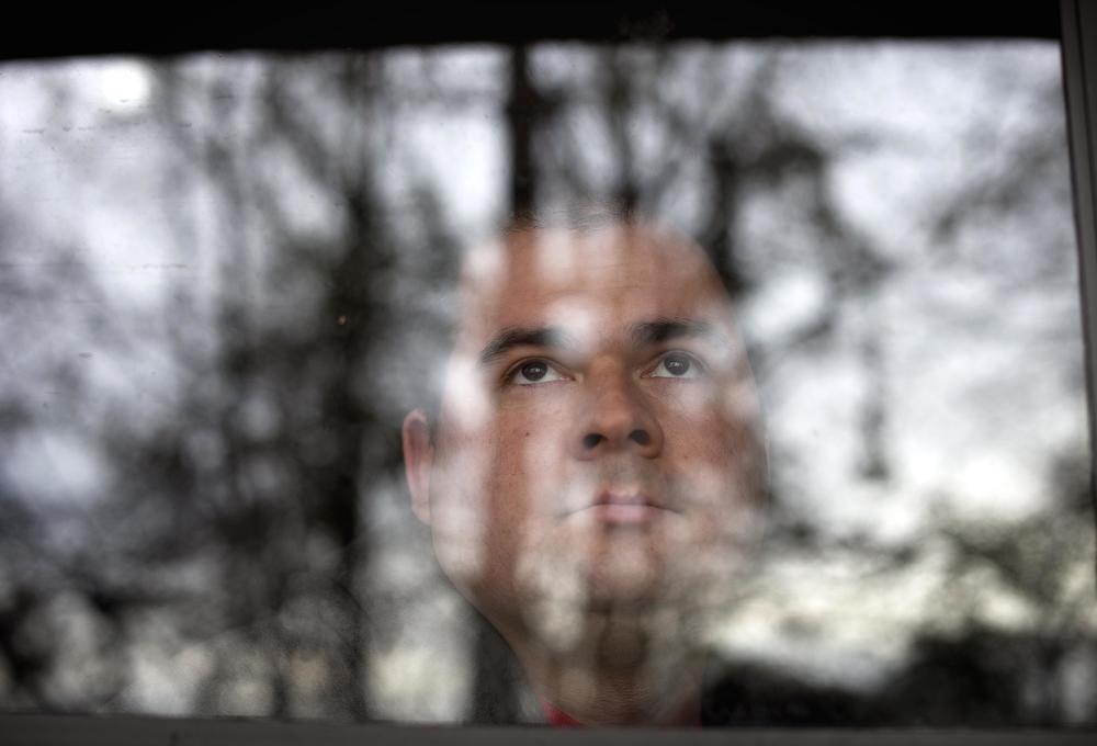 David Nathan Thompson looks out from his apartment in Columbus, Georgia, in 2011.