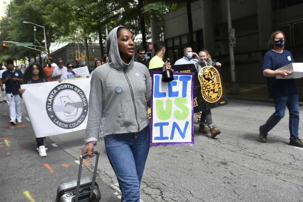  Klaire Gumbs, an organizer with the New Georgia Project, marches to the Georgia Department of Labor headquarters in Atlanta. 