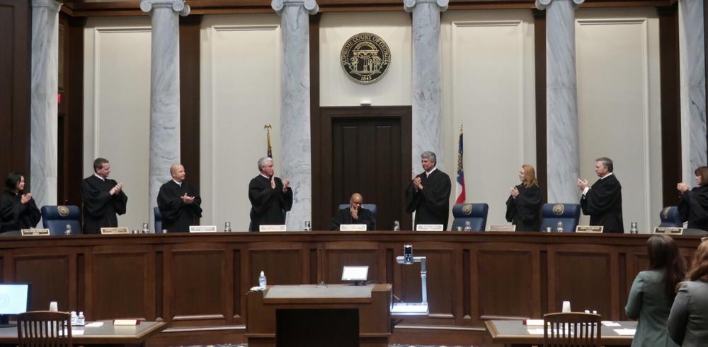 Georgia Supreme Court justices applaud outgoing Chief Justice Harold Melton as he presides over his final oral arguments on June 9, the first day the courtroom reopened for in-person proceedings since March 2020. Melton's resignation effective July 1 allows Gov. Brian Kemp his third opportunity to reshape the court. Stanley Dunlap/Georgia Recorder