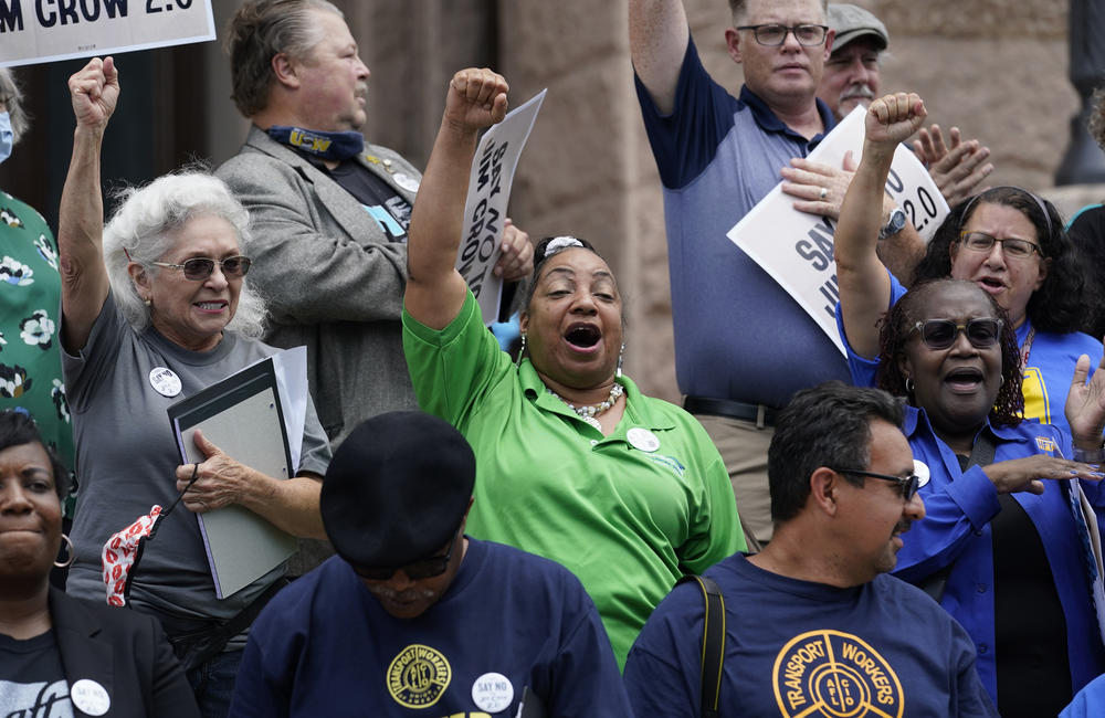 Demonstrators join a rally to protest proposed voting bills on the steps of the Texas Capitol, Tuesday, July 13, 2021, in Austin, Texas.