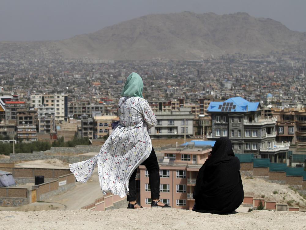 Afghan women look at the skyline of Kabul in September 2020.