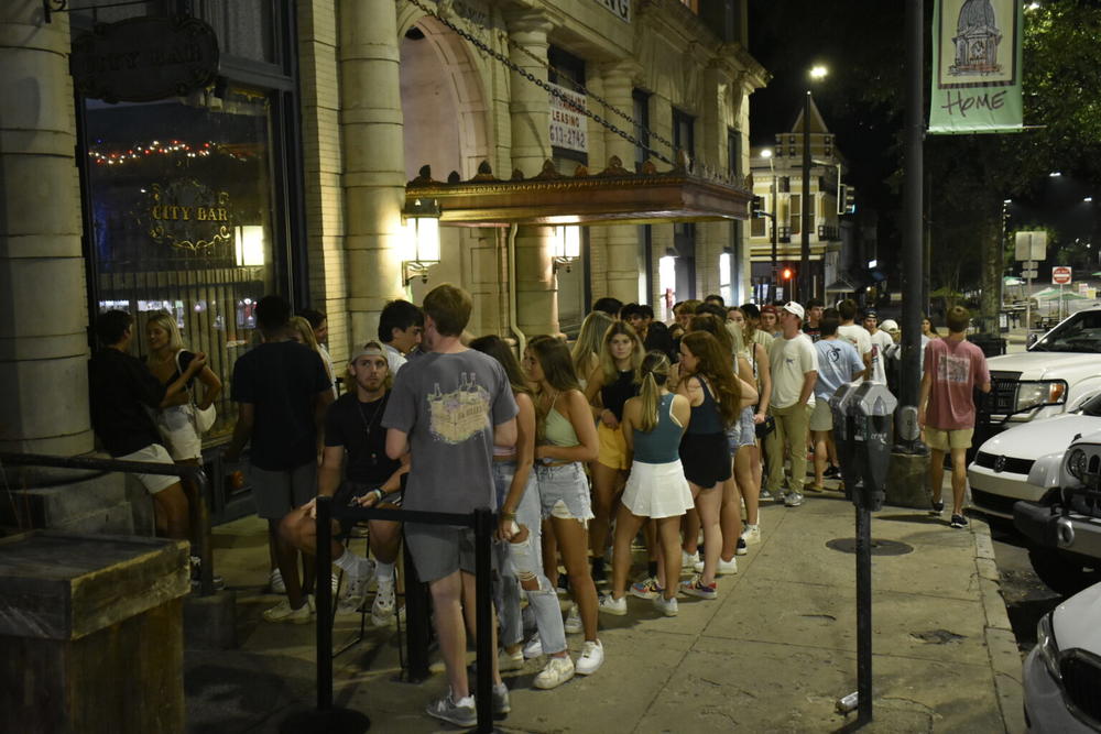 As the Athens/Clarke Commission voted to institute a mask mandate, unmasked young people crowded the streets outside. 